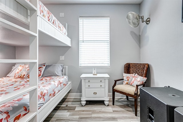 bedroom featuring multiple windows and light wood-type flooring