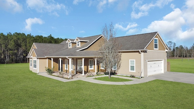 view of front of property featuring a garage, a front yard, covered porch, and driveway