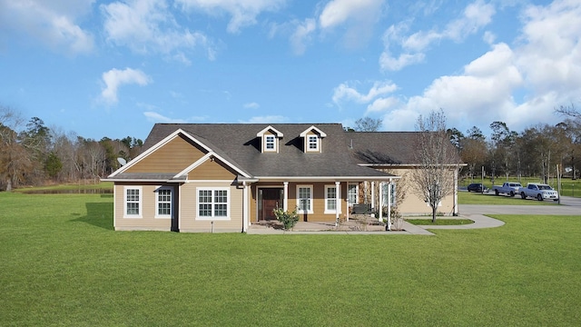 view of front of home featuring covered porch and a front lawn