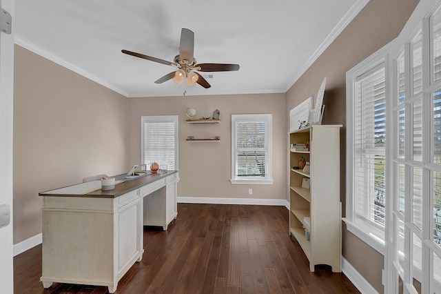 unfurnished office with ornamental molding, dark wood-type flooring, a ceiling fan, and baseboards