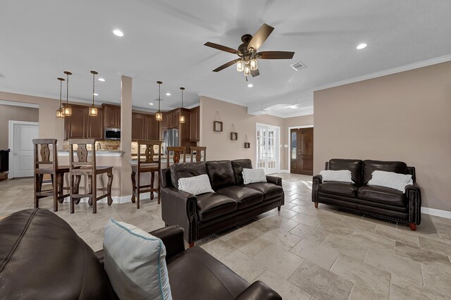 living room with crown molding and ceiling fan