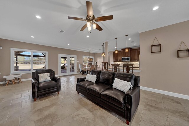 living room featuring french doors and ceiling fan