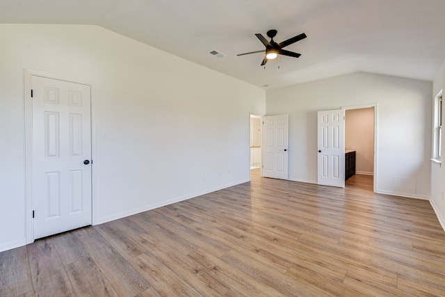 unfurnished bedroom with ceiling fan, lofted ceiling, and light hardwood / wood-style floors