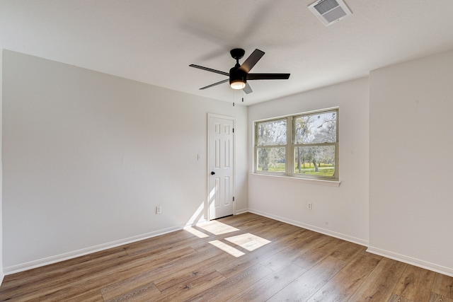 spare room with ceiling fan and light wood-type flooring