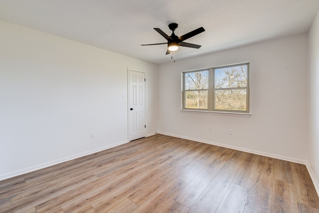 empty room featuring ceiling fan and light wood-type flooring