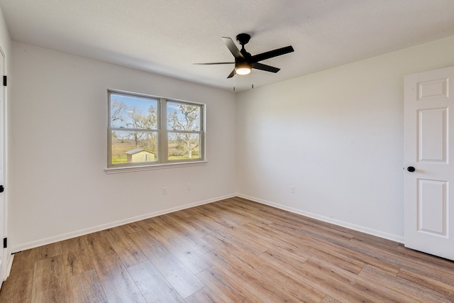 unfurnished room featuring ceiling fan and light hardwood / wood-style flooring