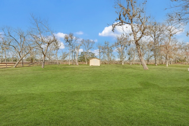 view of yard with a storage unit and a rural view