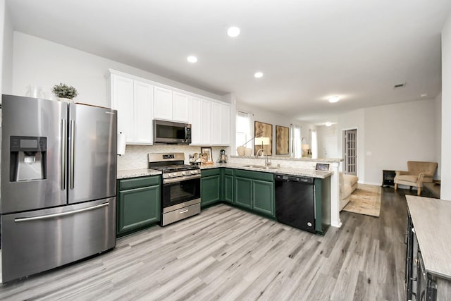 kitchen featuring appliances with stainless steel finishes, sink, white cabinets, green cabinetry, and light hardwood / wood-style flooring