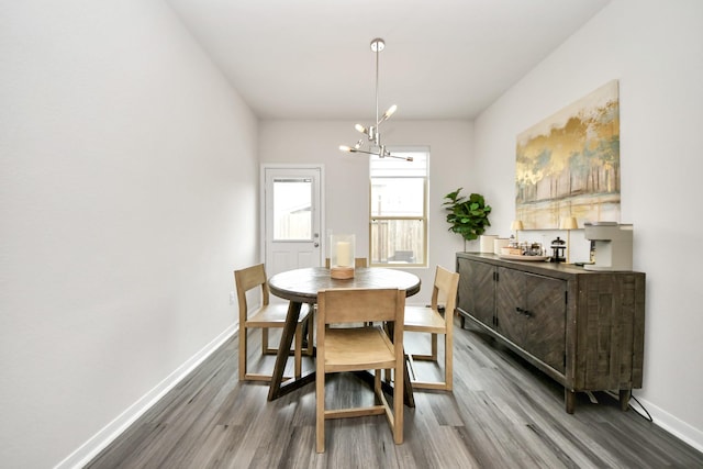 dining room featuring hardwood / wood-style floors and a notable chandelier