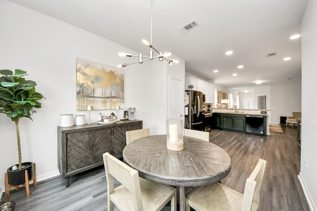 dining room featuring light hardwood / wood-style floors and a chandelier