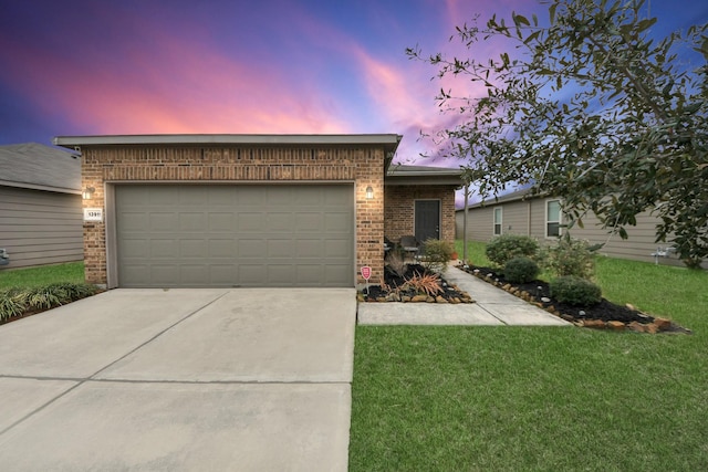 view of front of home with a yard and a garage