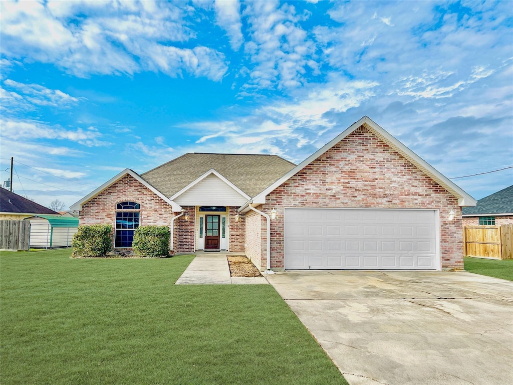 view of front of home featuring a garage and a front yard