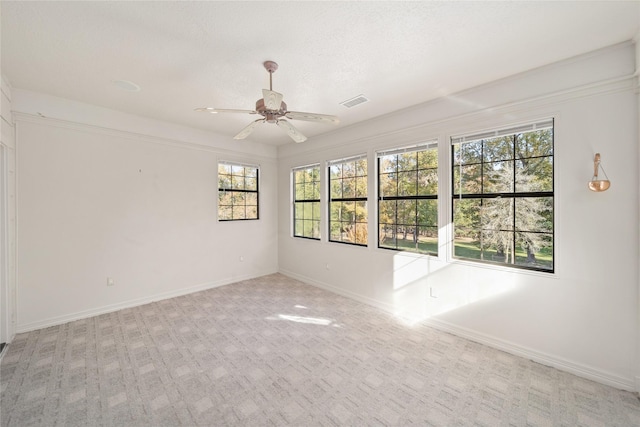 carpeted empty room featuring a textured ceiling and ceiling fan