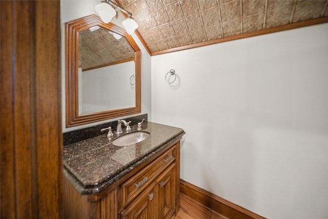 bathroom with vanity and ornamental molding