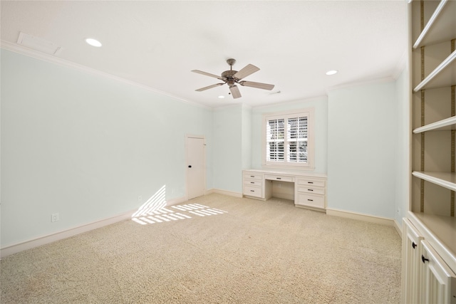 unfurnished bedroom with crown molding, light colored carpet, and ceiling fan