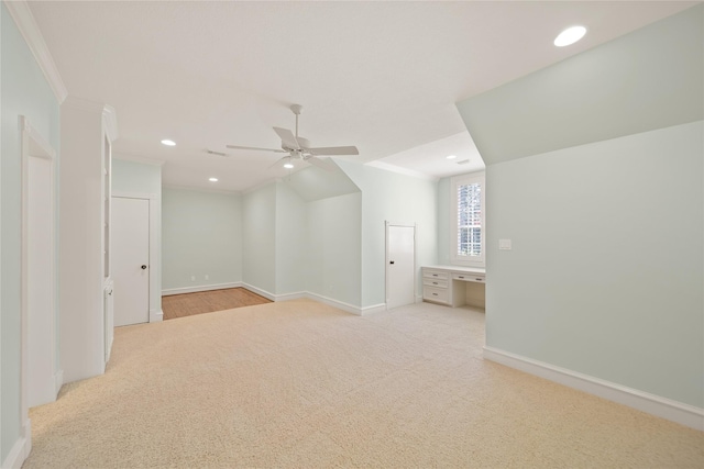 additional living space featuring light carpet and ceiling fan