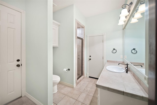 bathroom with vanity, toilet, tile patterned floors, and walk in shower