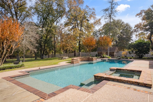 view of swimming pool featuring a patio area, a lawn, and an in ground hot tub