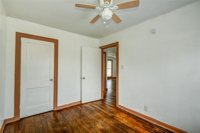 unfurnished bedroom featuring dark hardwood / wood-style floors and ceiling fan