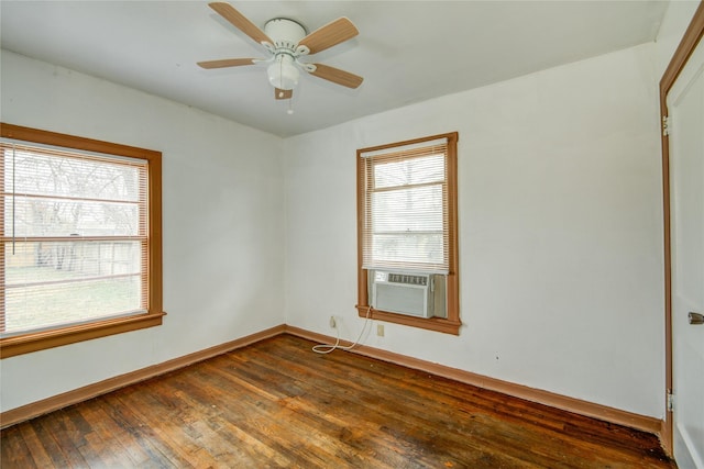 spare room featuring cooling unit, dark hardwood / wood-style floors, and ceiling fan