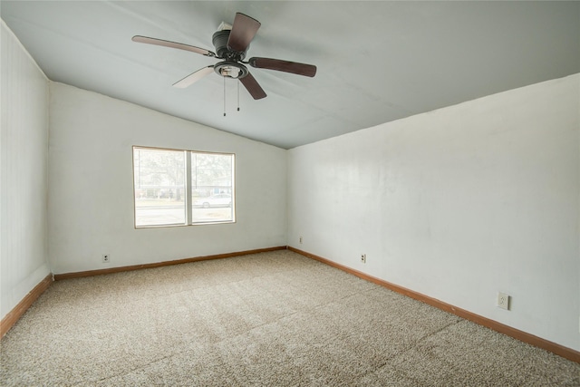 spare room featuring lofted ceiling, carpet floors, and ceiling fan