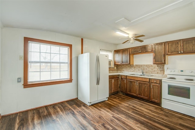 kitchen with sink, white appliances, ceiling fan, dark hardwood / wood-style floors, and decorative backsplash