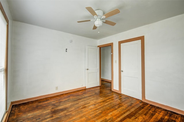 unfurnished bedroom with ceiling fan and dark hardwood / wood-style floors