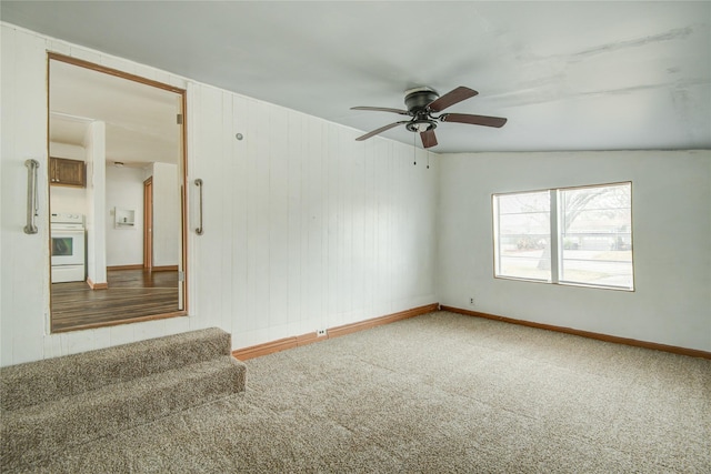 carpeted spare room featuring ceiling fan