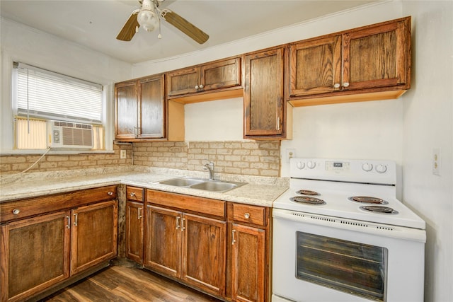 kitchen featuring sink, backsplash, white electric range oven, ceiling fan, and dark wood-type flooring