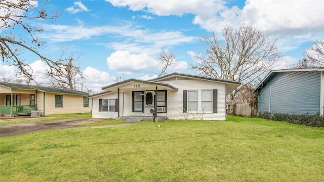 view of front of home with a front yard and cooling unit