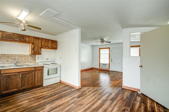 kitchen featuring ceiling fan, white electric range, dark hardwood / wood-style floors, and sink