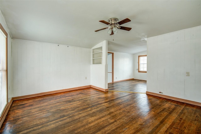 spare room featuring lofted ceiling, dark wood-type flooring, and ceiling fan