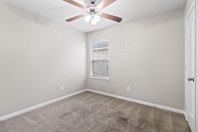 unfurnished room with ceiling fan and carpet