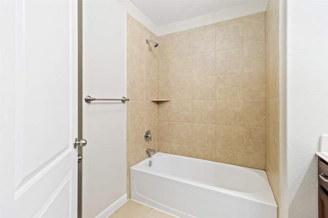 bathroom with tile patterned floors, vanity, and tiled shower / bath combo