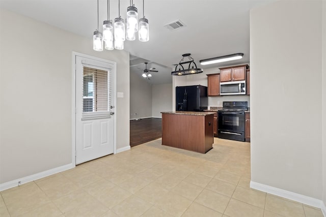 kitchen featuring decorative light fixtures, black appliances, ceiling fan, and a kitchen island