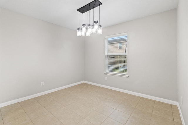 unfurnished room featuring a notable chandelier