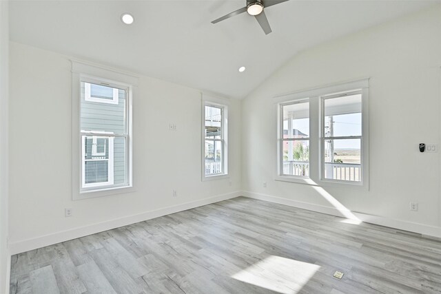 unfurnished room featuring lofted ceiling, ceiling fan, and light wood-type flooring