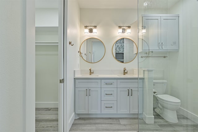 bathroom featuring hardwood / wood-style flooring, vanity, and toilet