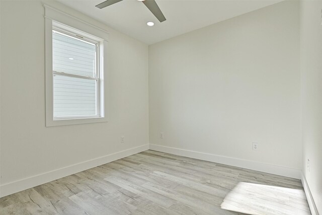 spare room featuring light hardwood / wood-style floors and ceiling fan