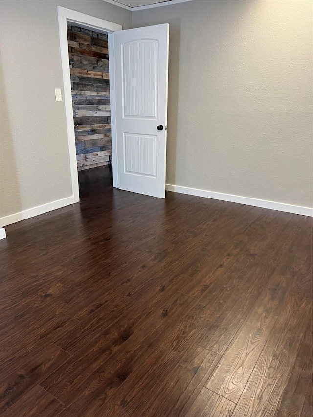 spare room featuring dark wood-type flooring