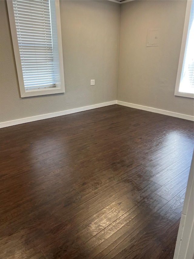 unfurnished room with dark hardwood / wood-style floors