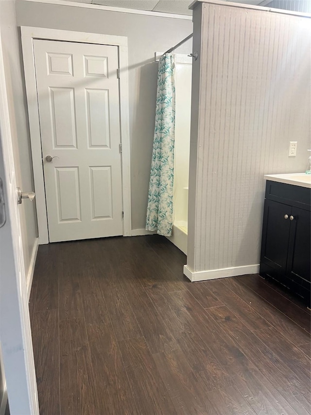 bathroom featuring wood-type flooring, shower / tub combo, and vanity