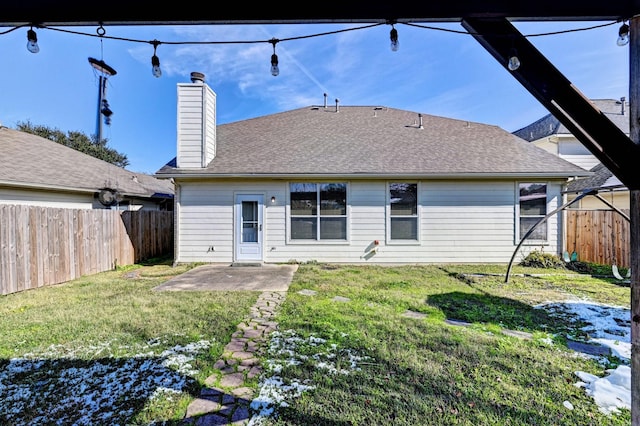 rear view of property featuring a yard and a patio area