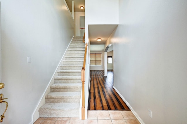 stairway with tile patterned flooring