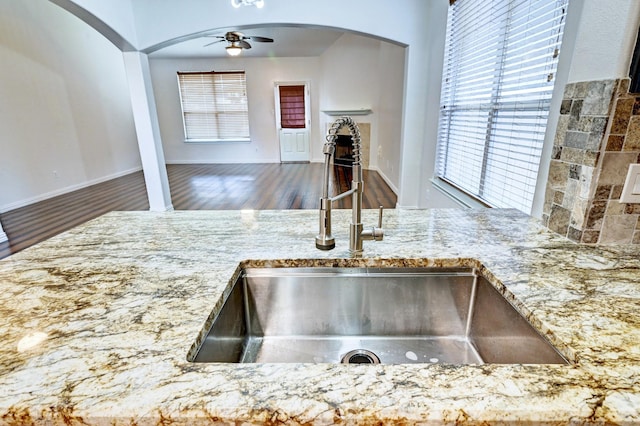 kitchen with wood-type flooring, plenty of natural light, sink, and ceiling fan