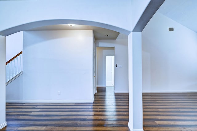 empty room featuring dark wood-type flooring