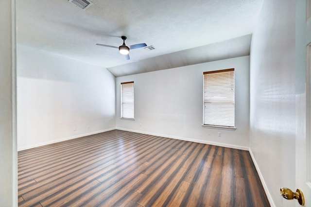 unfurnished room with dark hardwood / wood-style flooring, lofted ceiling, a textured ceiling, and ceiling fan