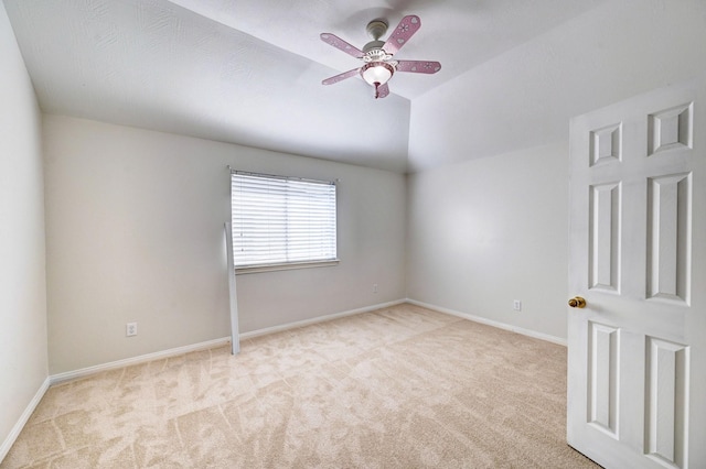 unfurnished room with light carpet, vaulted ceiling, and ceiling fan