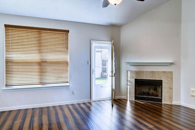 unfurnished living room with ceiling fan, a fireplace, and dark hardwood / wood-style floors