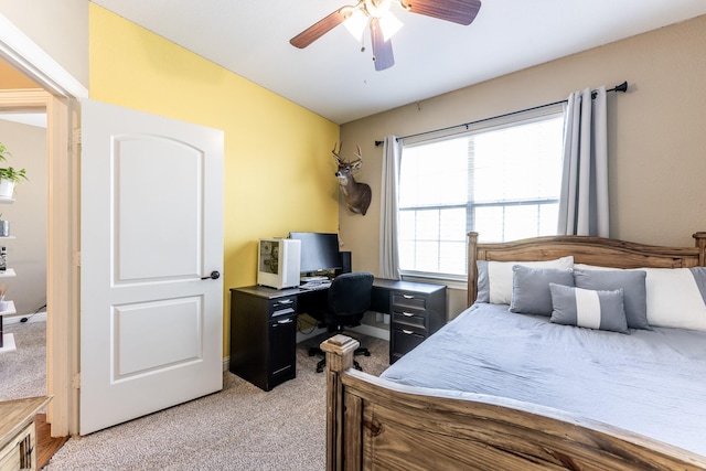 bedroom with vaulted ceiling, light colored carpet, and ceiling fan